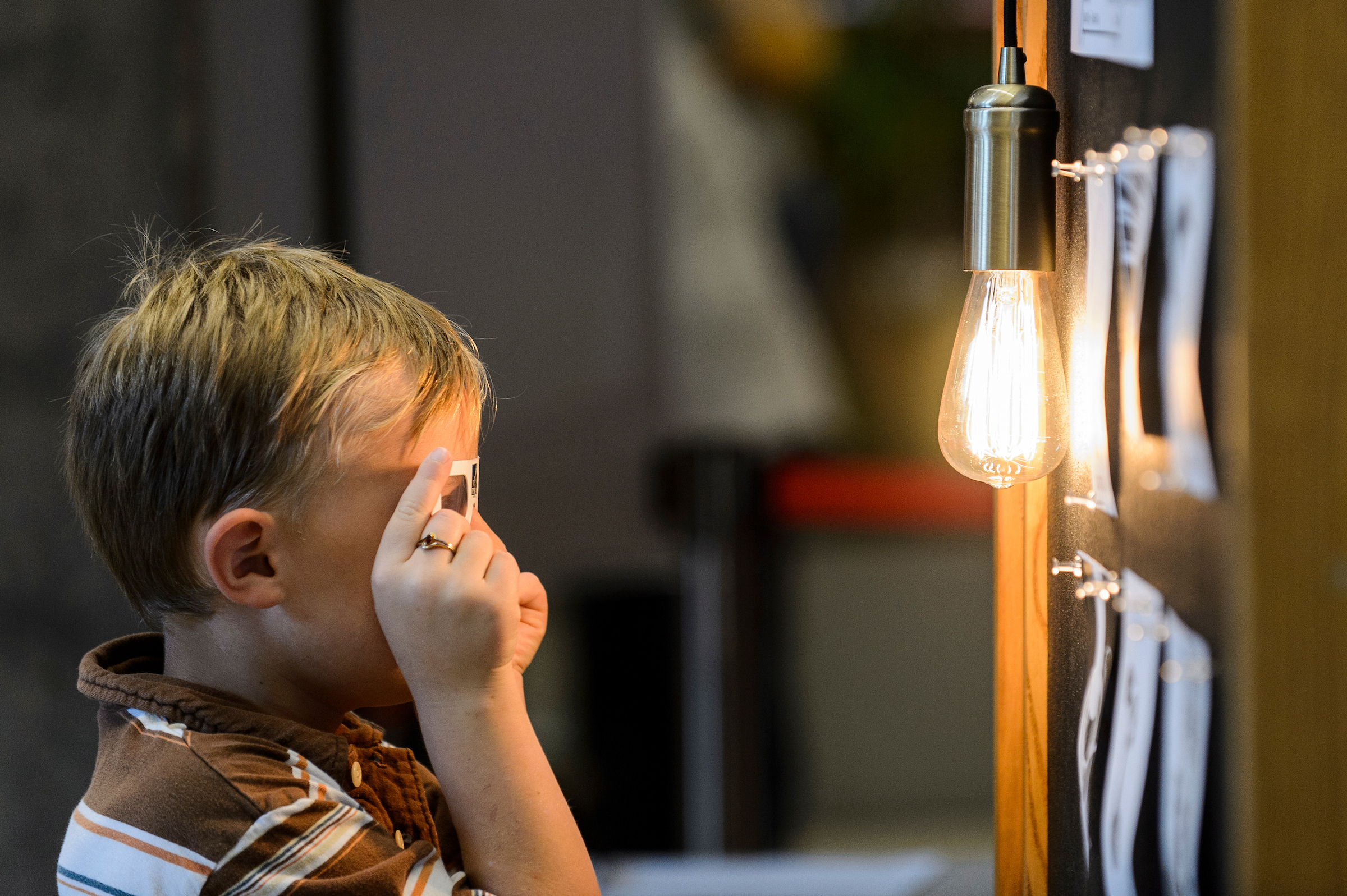 Boy looking at light bulb