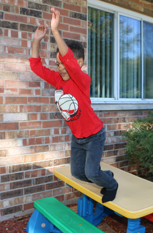 Benji Martin playing in front of his home