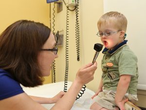 Doctor with young patient at Waisman Down syndrome Clinic
