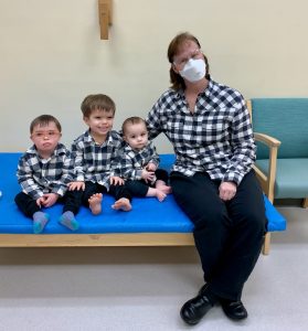 Waisman Provider Peggy Modaff sits with three children.