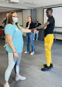 Hedy demonstrates techniques of passive self-protection during the Managing