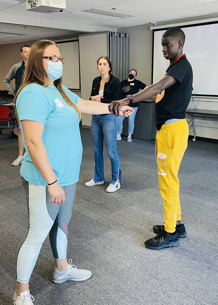 Hedy demonstrates techniques of passive self-protection during the Managing