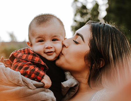 Mom kissing baby