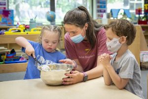 Children help prepare cookie dough