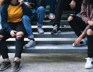 Teens sitting on a bench