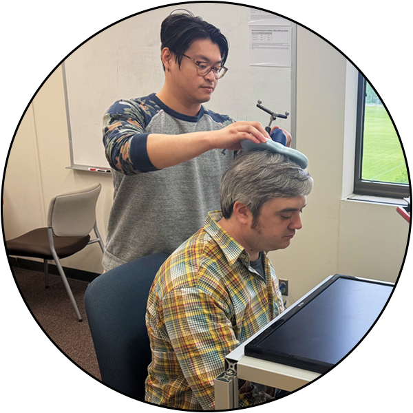 An NMS user piloting his TMS protocol with a lab member
